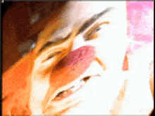 a close up of a person 's face with a pink shadow