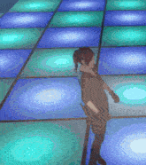 a pixelated image of a person dancing on a blue and green dance floor
