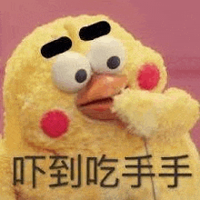 a stuffed chicken with big eyes and red spots is eating something .