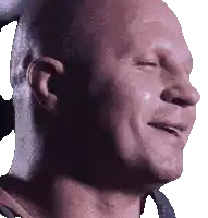 a bald man with his eyes closed is smiling