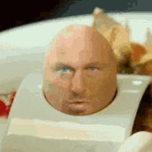 an egg with a man 's face sticking out of it .