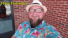 a man wearing a hat and glasses is smiling and says hey friends