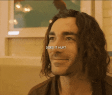 a close up of a man 's face with the words " does it hurt " on the bottom