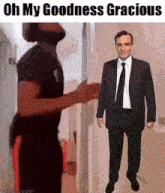 a man in a suit and tie is standing next to a man in a black shirt