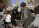 a group of people are gathered in front of a poster that says ' the ambush of the bear ' on it