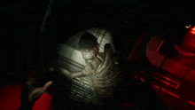 a skeleton in a dark room with red lights on