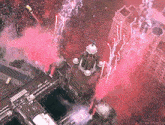 an aerial view of a city with pink smoke coming out of the buildings