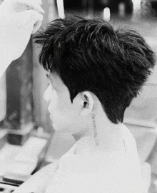 a black and white photo of a person with a tattoo on the back of their neck that says " do not disturb "