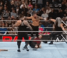 a group of men are wrestling in a wrestling ring with a sign that says i do believe in uncle nobby