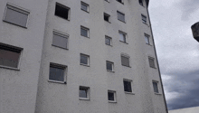 a tall building with a lot of windows on a cloudy day