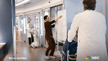 a nbc ad for chicago med shows two doctors standing in a hospital room