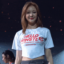 a woman is wearing a white shirt that says hello monsters