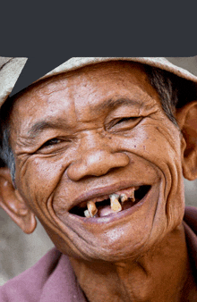 a close up of a man 's face with a hat on