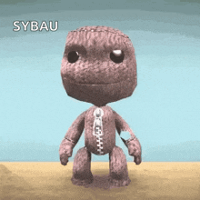 a stuffed toy with a zipper on its chest is standing on a table with the word sybau written on the bottom