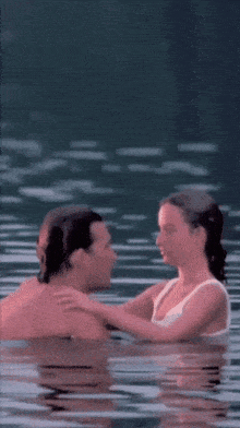 a man and a woman are swimming in the water