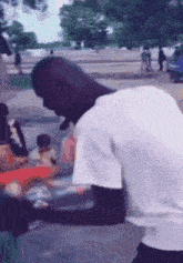 a man in a white shirt is standing on a sidewalk