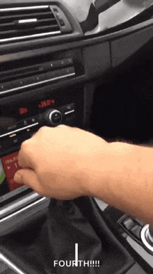 a person is adjusting the radio in a car and the word fourth is on the bottom of the screen