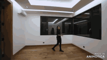 a woman walking in a room with the words made in animotica on the bottom right