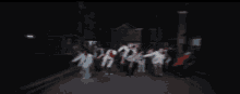 a group of people are dancing in front of a building