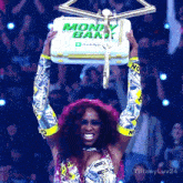 a woman is holding up a box that says money bank cash app