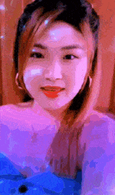 a close up of a woman 's face with a pink and purple background