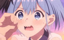 a close up of a girl 's face with blue hair