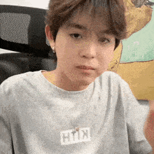 a person wearing a t-shirt that has the word kith on it