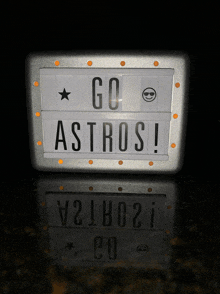 a sign that says go astros is lit up