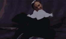 a man is laying on a bed with a cartoon of a woman on his back .