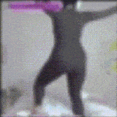 a blurry picture of a person in a black suit standing on a bed .