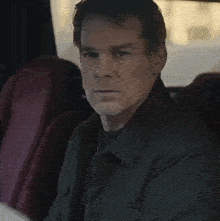 a man with a beard is sitting in a car