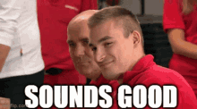 a man in a red shirt is sitting next to another man in a red shirt and the words sounds good are above him .