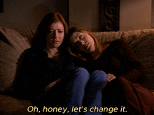 two women are sitting on a couch with the discovery channel has koala bears
