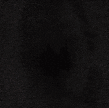 a blurry picture of a man 's face with his eyes glowing