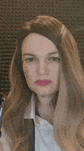 a woman with a tattoo on her face has a wig on
