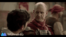 a man in armor is talking to another man with the words momento below him