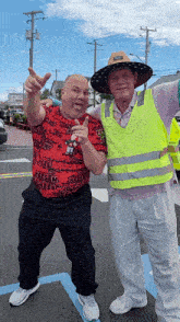 two men posing for a picture with one wearing a shirt that says " cheesy " on it