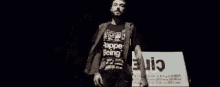 a man wearing a black shirt that says rapper being