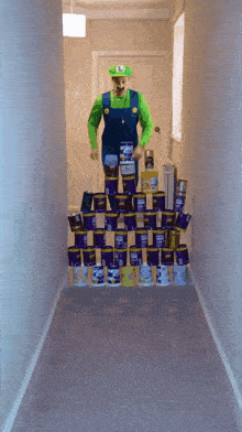 a man dressed as luigi is standing in a hallway surrounded by cans of paint