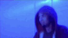 a blurry image of a person wearing a hoodie