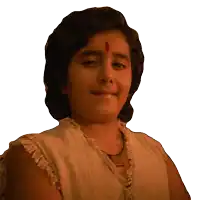a young boy with a red dot on his forehead smiles for the camera