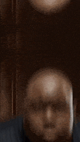 a man is sitting at a table with a plate of food .