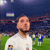 a soccer player wearing a white shirt that says ligue 1