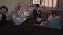 a woman in a nurse 's uniform sits in a hospital room