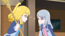 two anime girls are standing next to each other and one has a broom