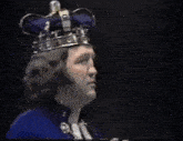 a man wearing a crown with the name brian gold belt maxine on it