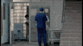 a man in a blue scrub top is talking to another man