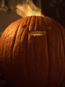 a pumpkin with a face carved into it is lit up