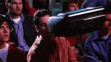 a group of people are sitting in front of a tv screen