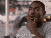 a man is making a funny face with his hand on his chin and the words `` on lamron '' .